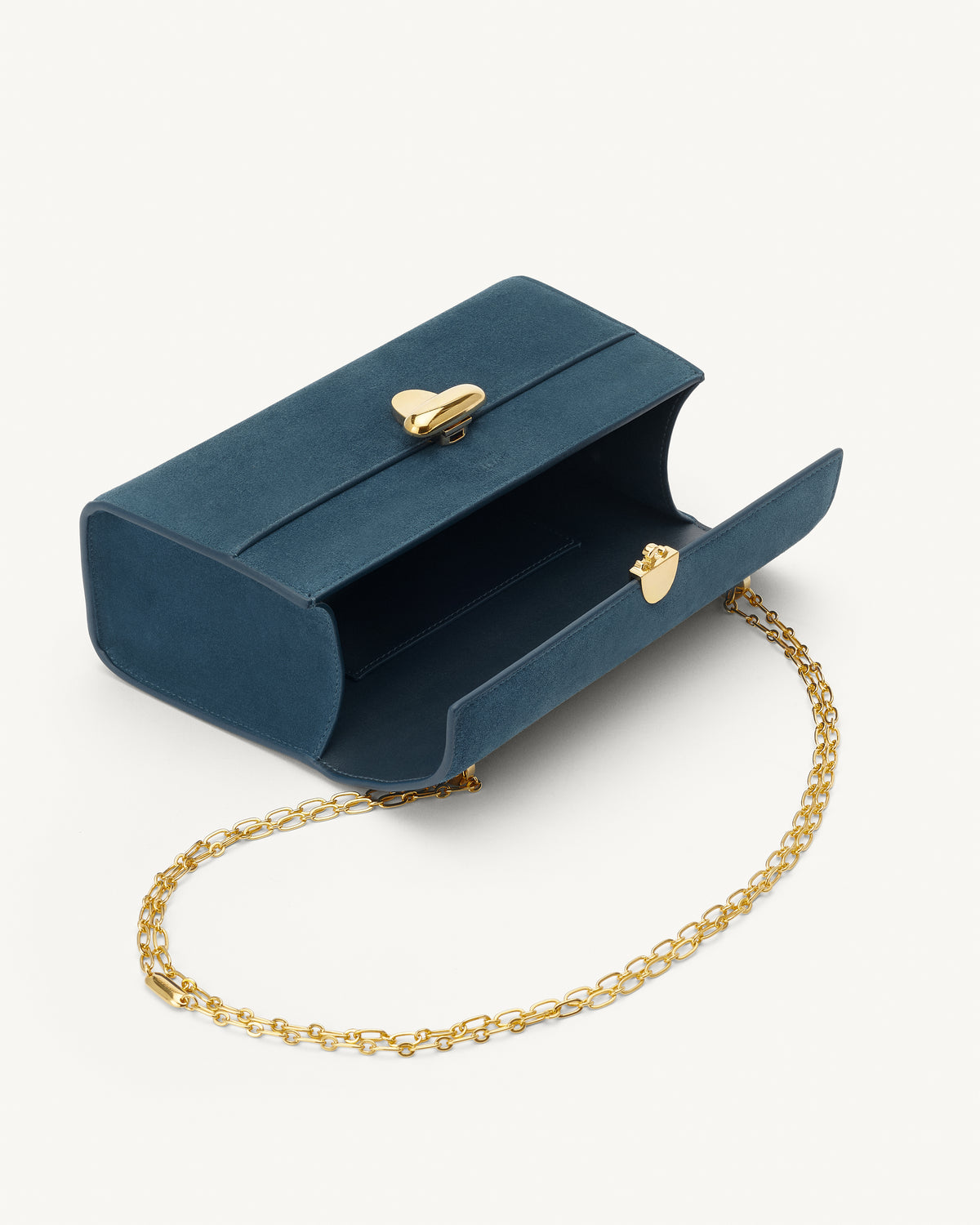 interior view of a baltic blue suede handbag with a gold clasp and gold chain on a white background 