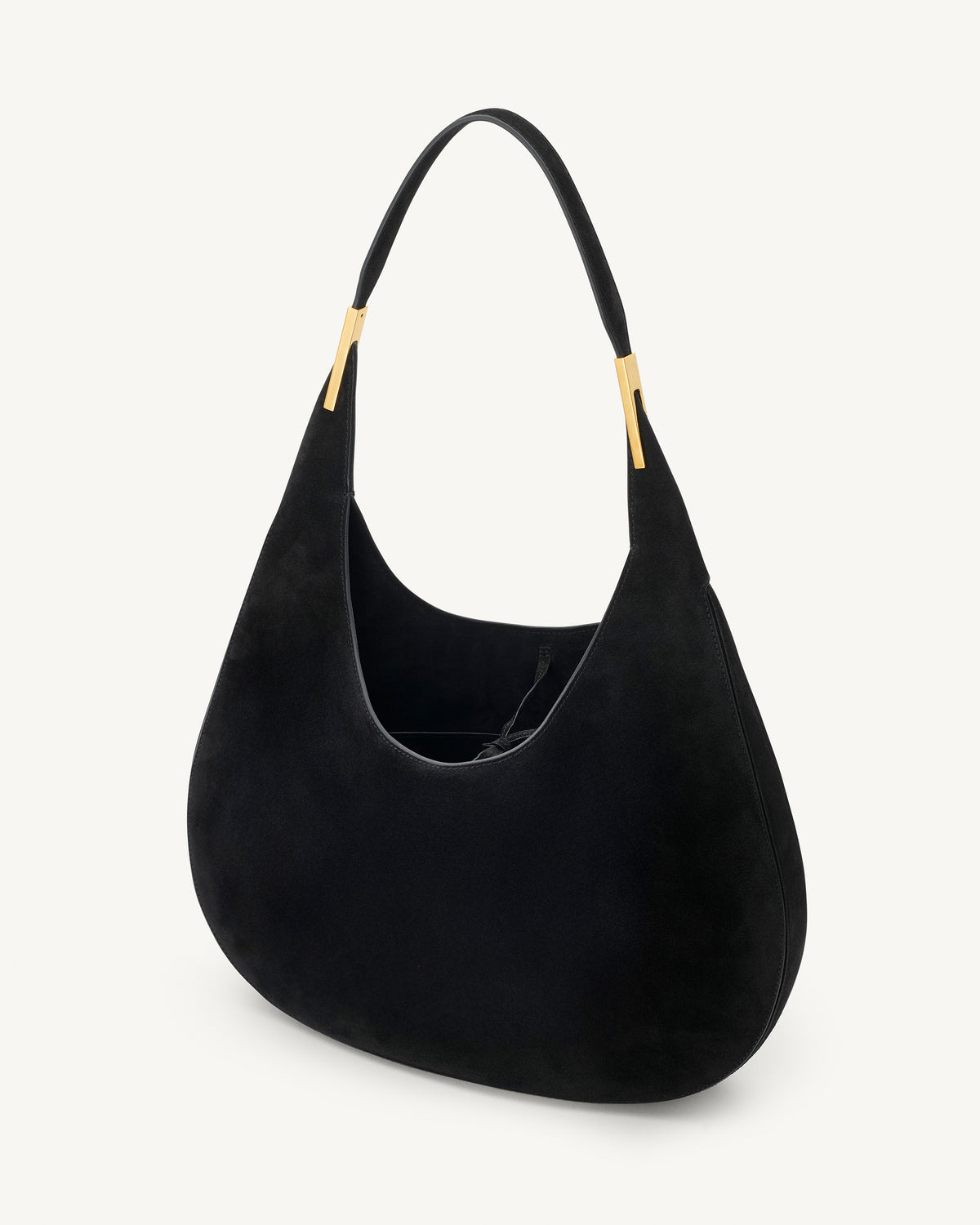 interior view of black suede bag with gold hardware on a white background