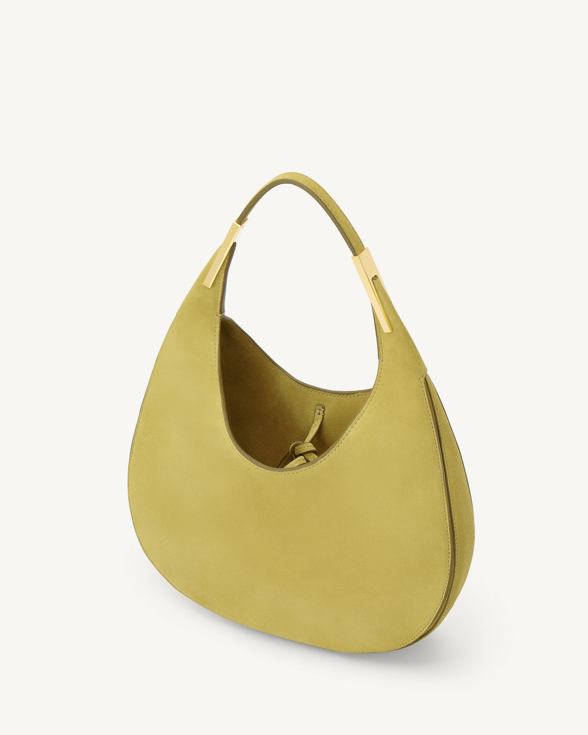 interior view of a chartreuse green suede bag with gold hardware on a white background