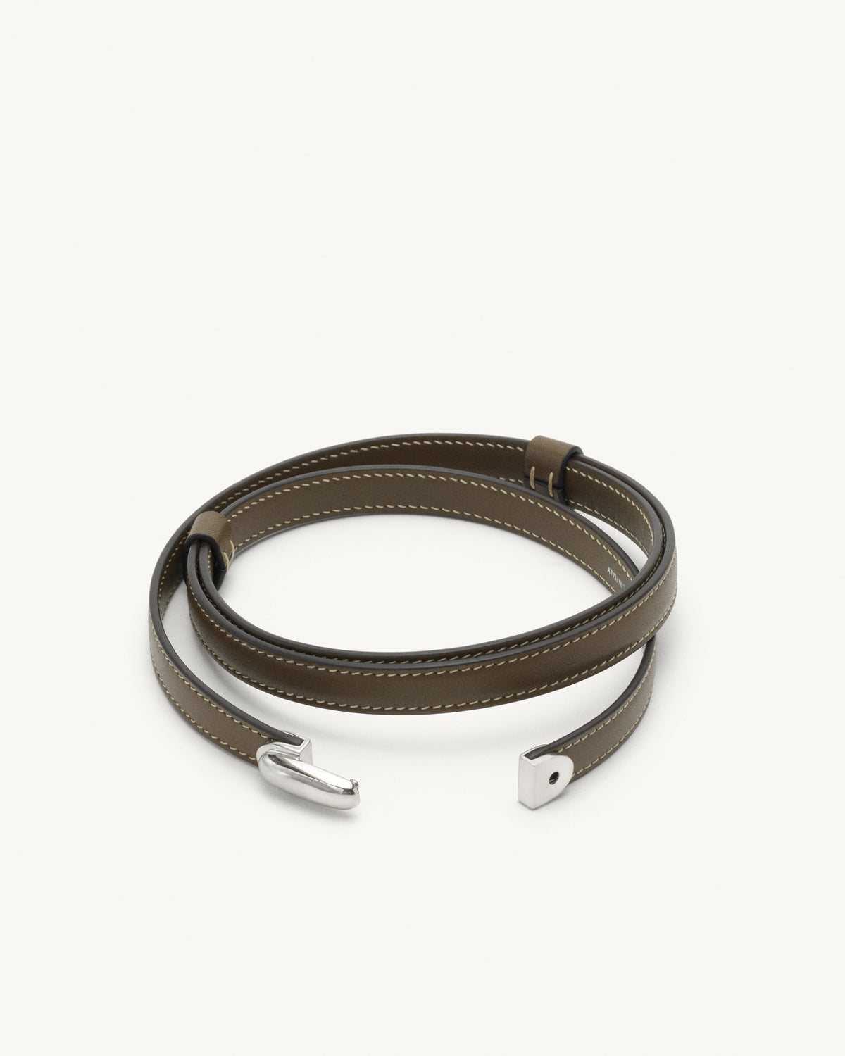 front view of mink brown leather belt with silver clasp on a white background
