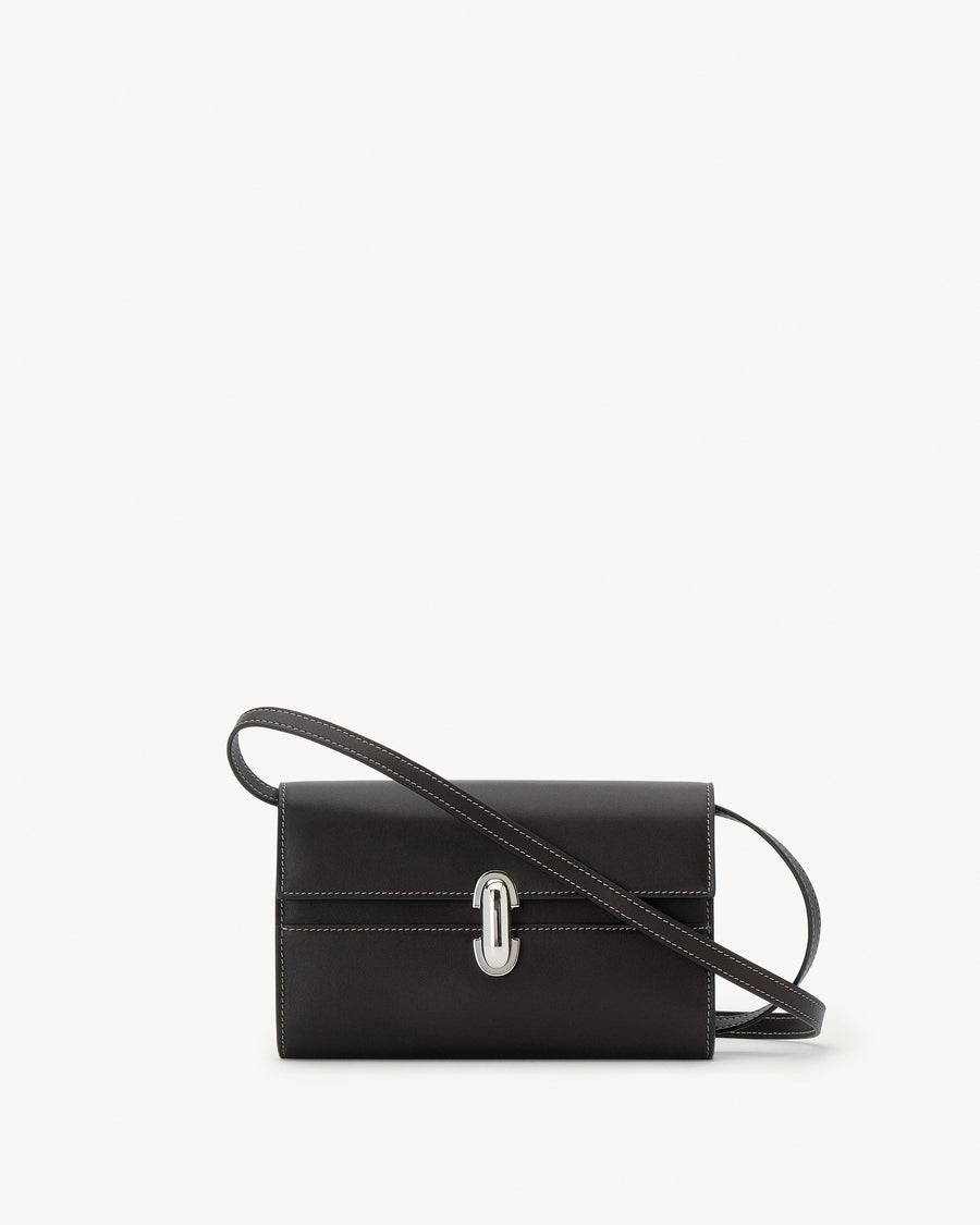 front view of a currant brown leather bag with a silver clasp on a white background