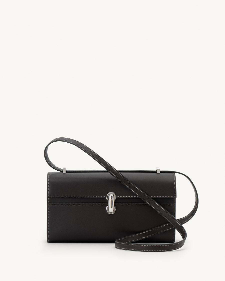 front view of a currant brown bag with silver clasp on a white background