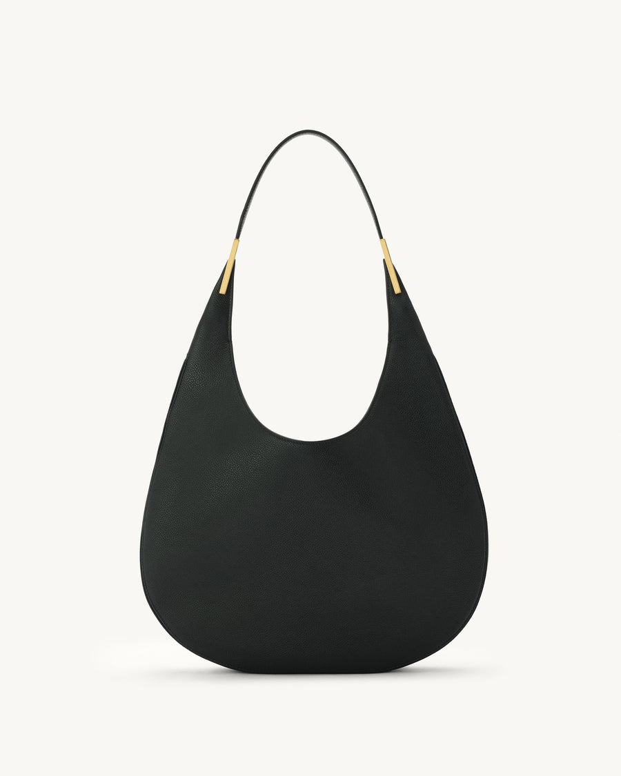 front view of black bag with gold hardware on a white background