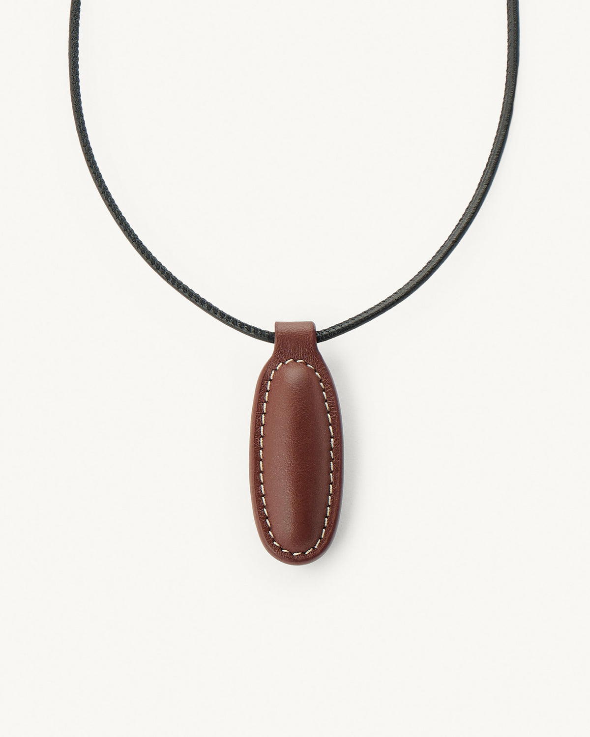 front view of espresso brown leather pendant on a white background