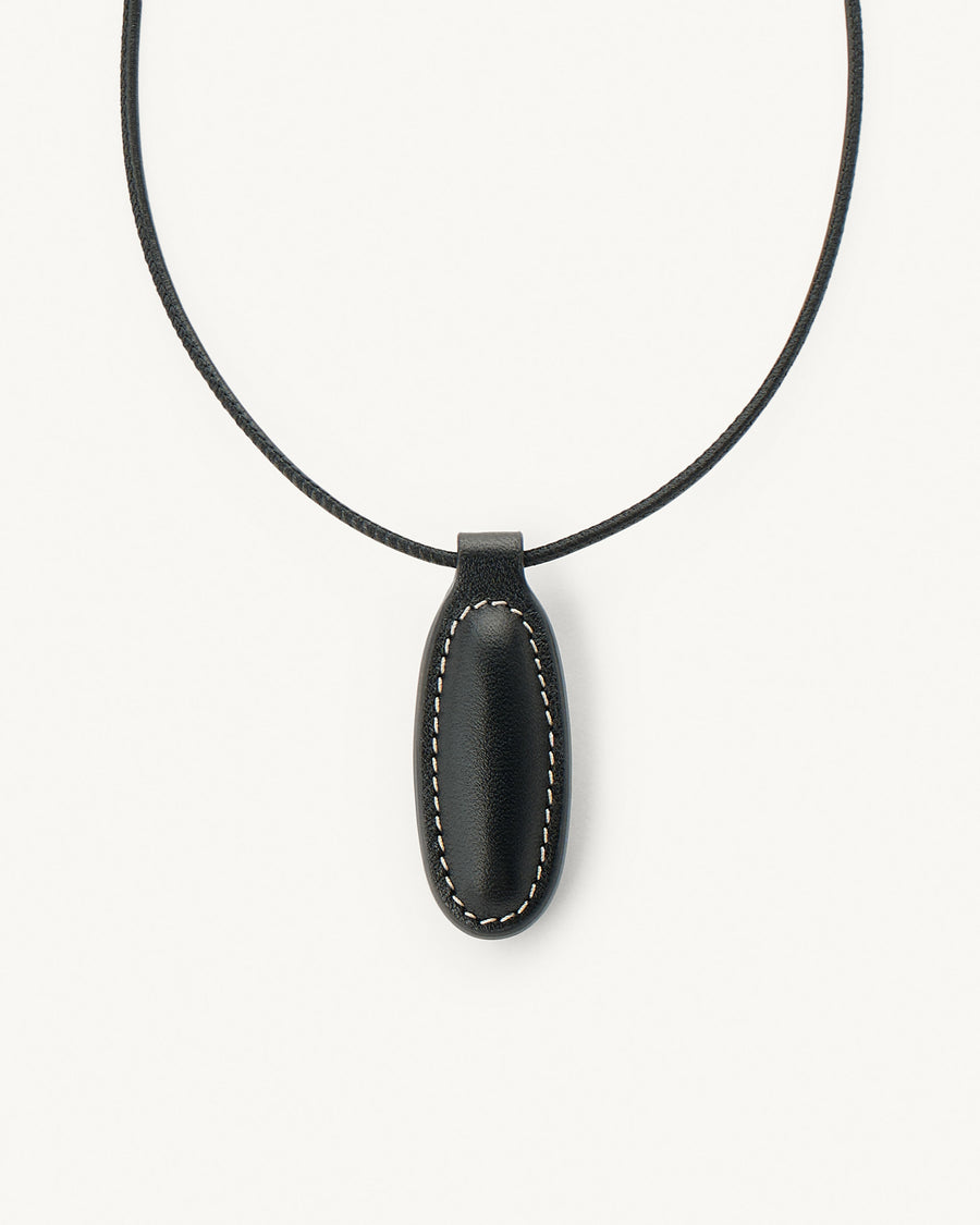 Black pendant necklace on a white background