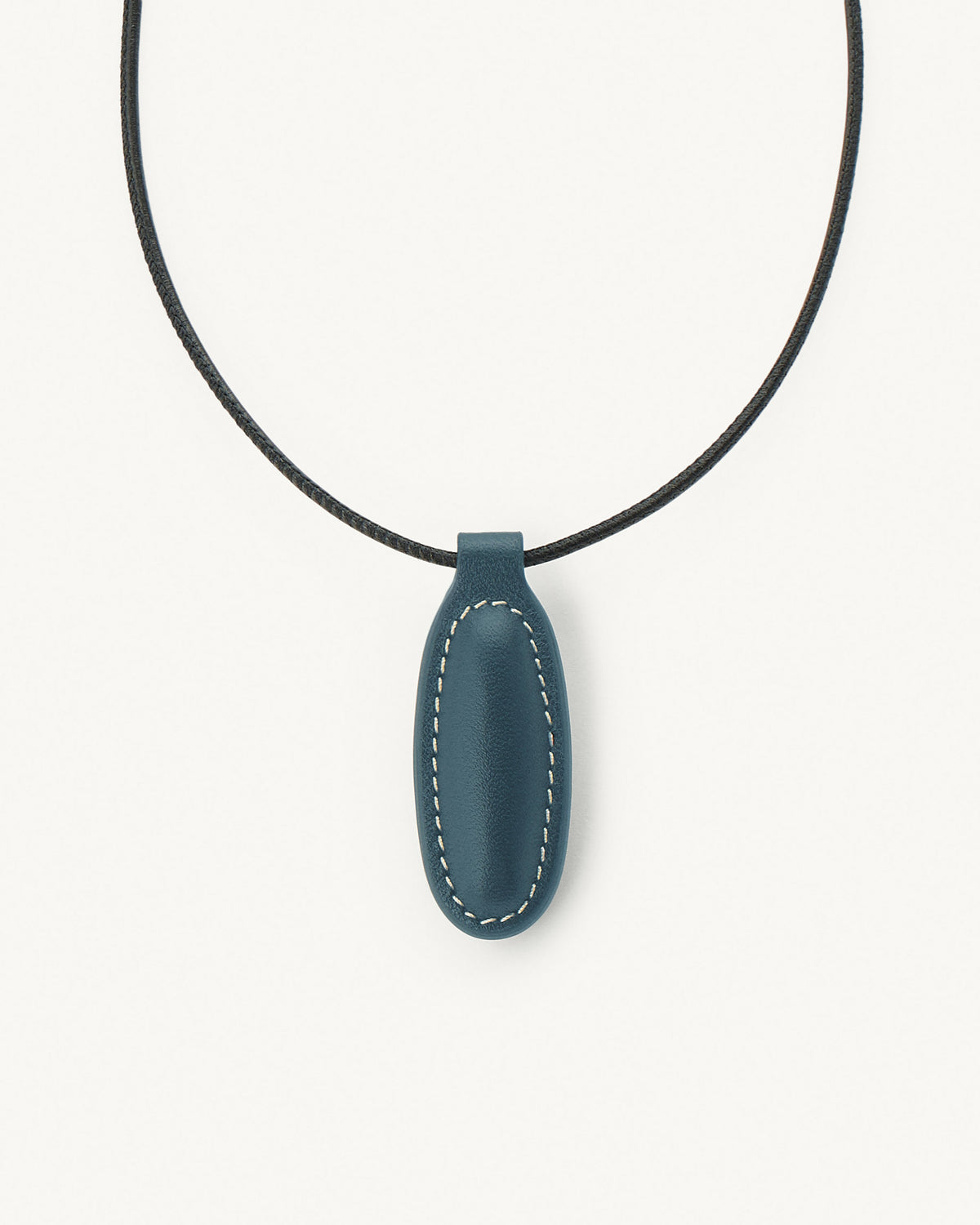 front view of ocean blue leather pendant on a white background