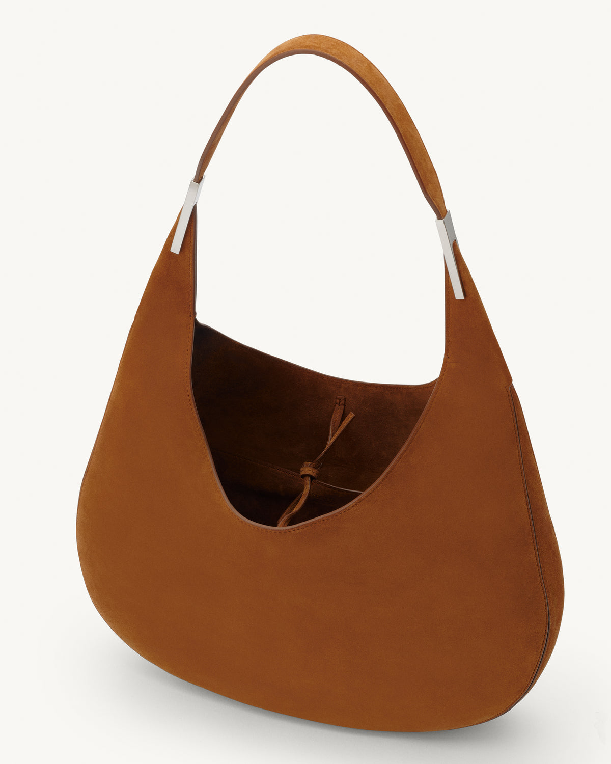 interior view of a cognac brown suede shoulder bag with silver hardware 