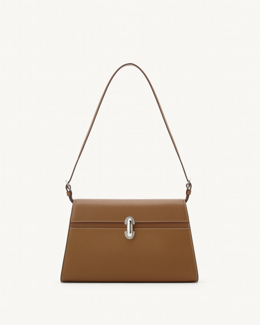 front view of a saddle brown leather bag with a silver clasp on a white background