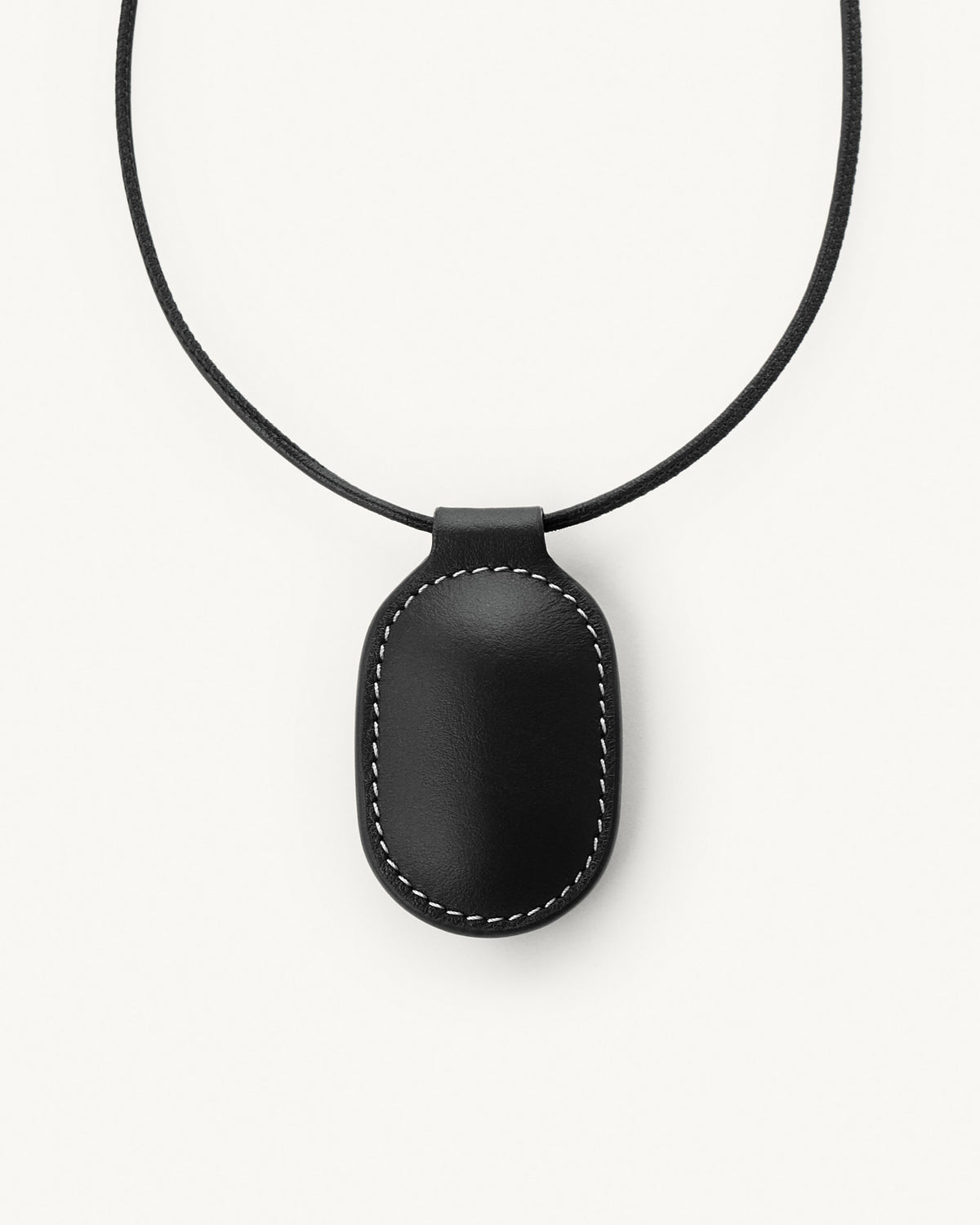 front view of black leather pendant on a white background