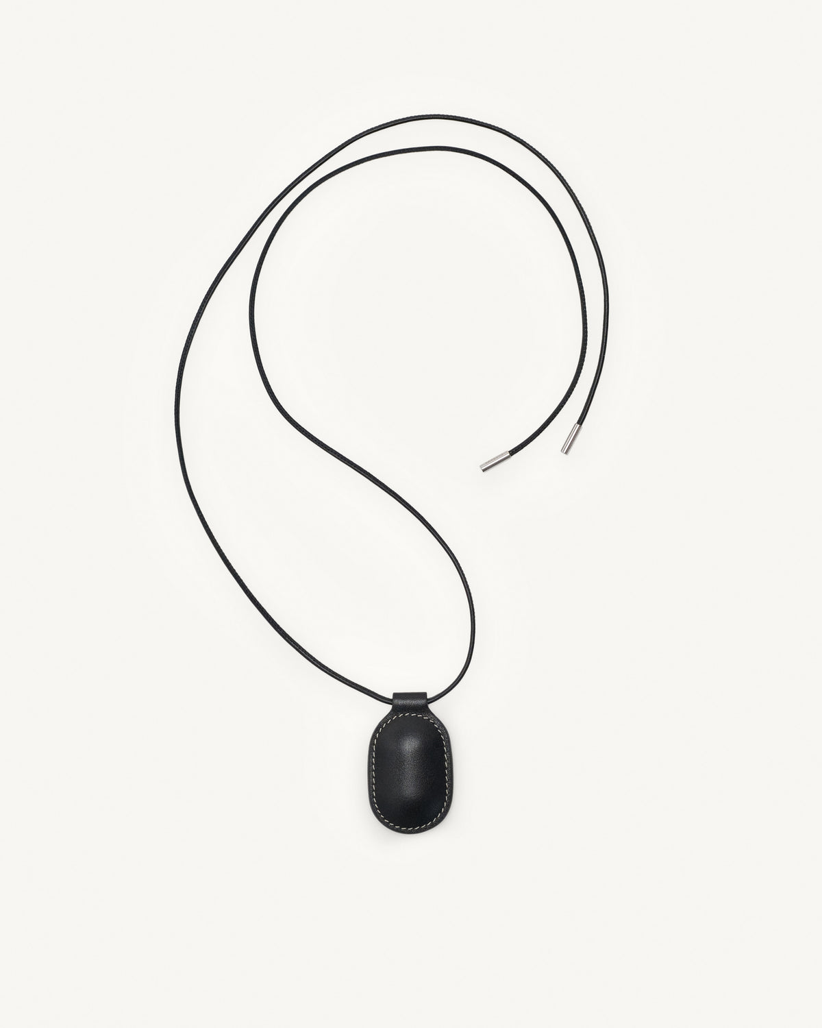 top view of black leather pendant on a white background