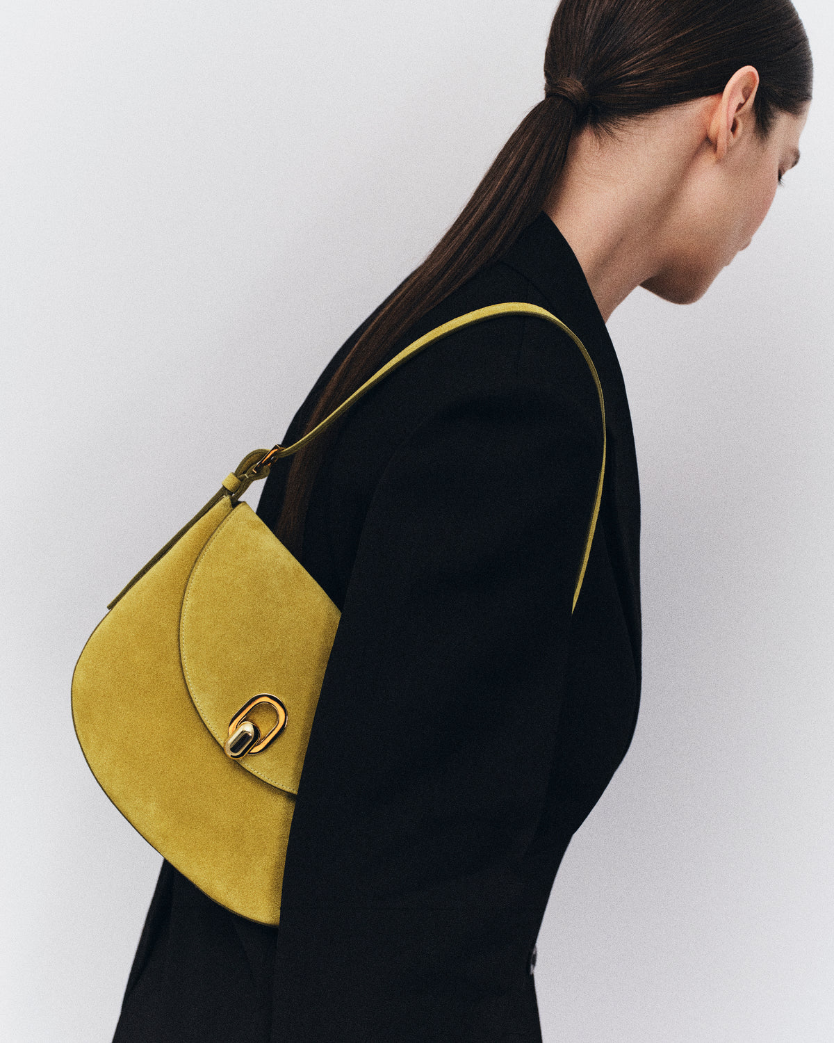 on model image of chartreuse green bag with silver clasp on a white background