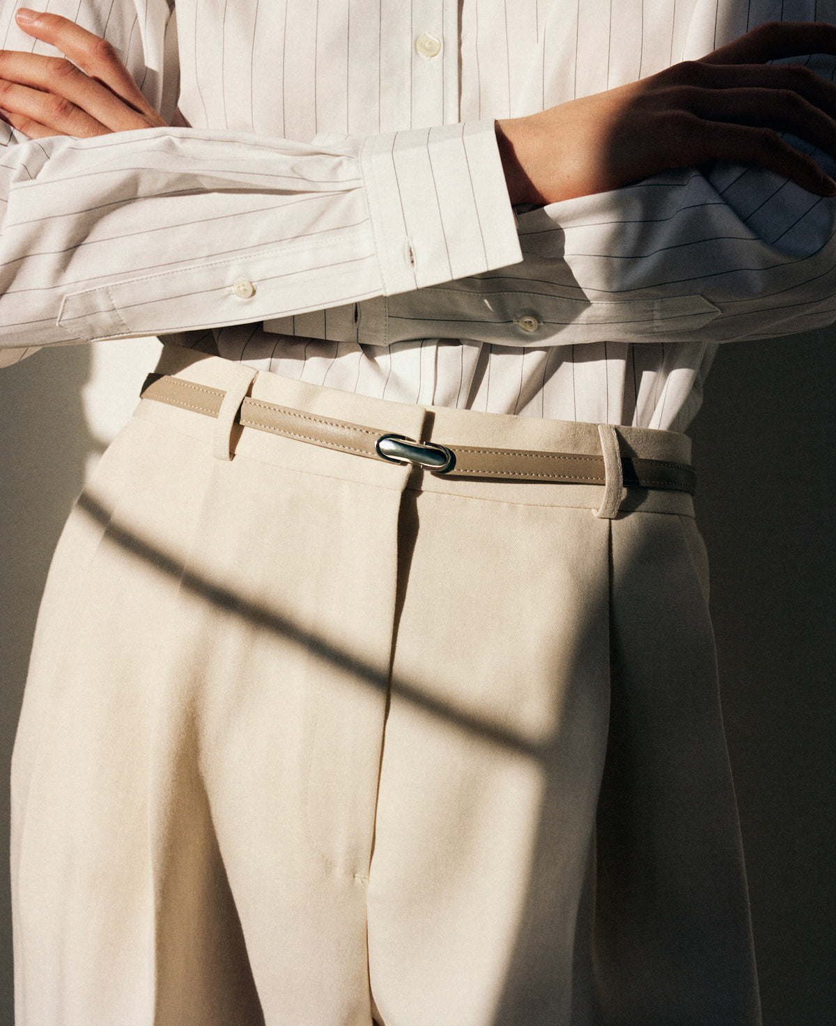 on model image of beige belt with silver clasp