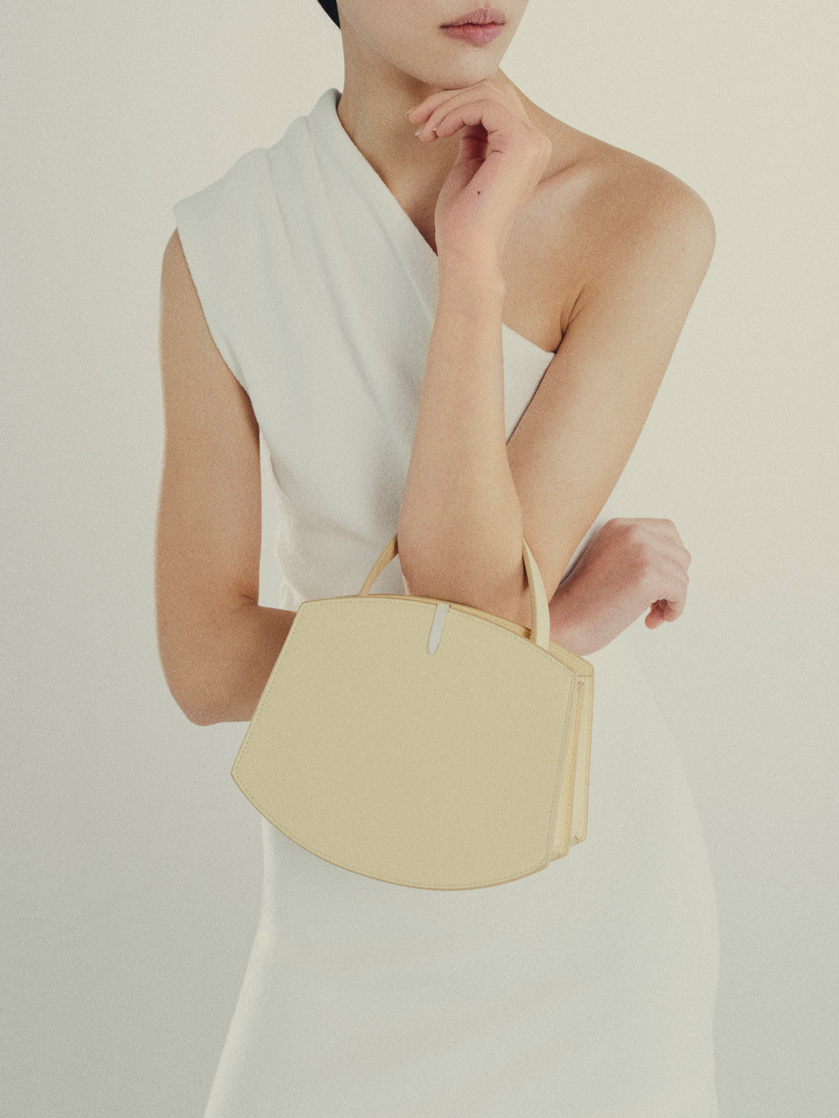 Woman holding ecru Florence 20 handbag