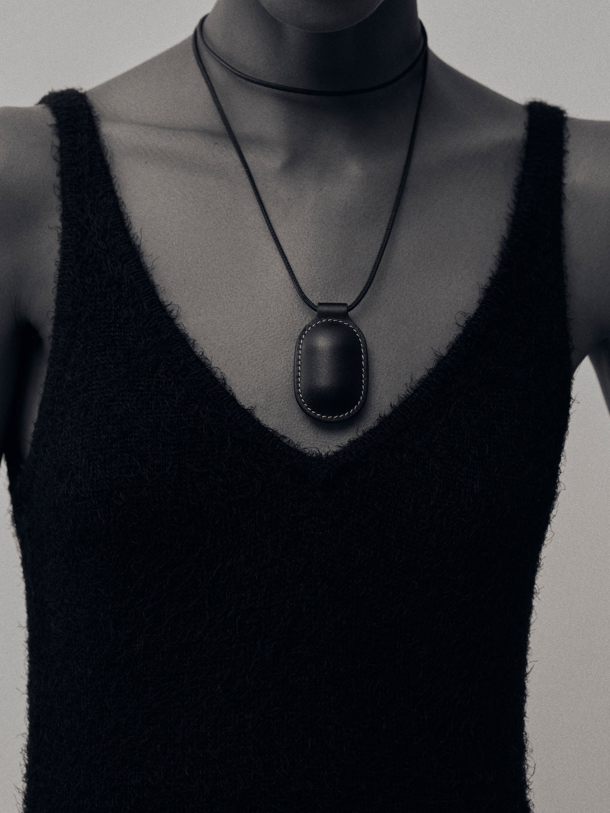 on model front view of black leather pendant