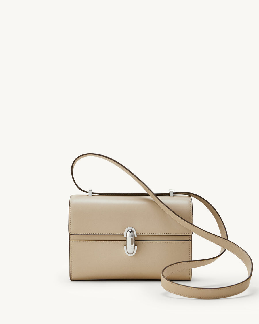 front view of bone beige bag with silver clasp on a white background