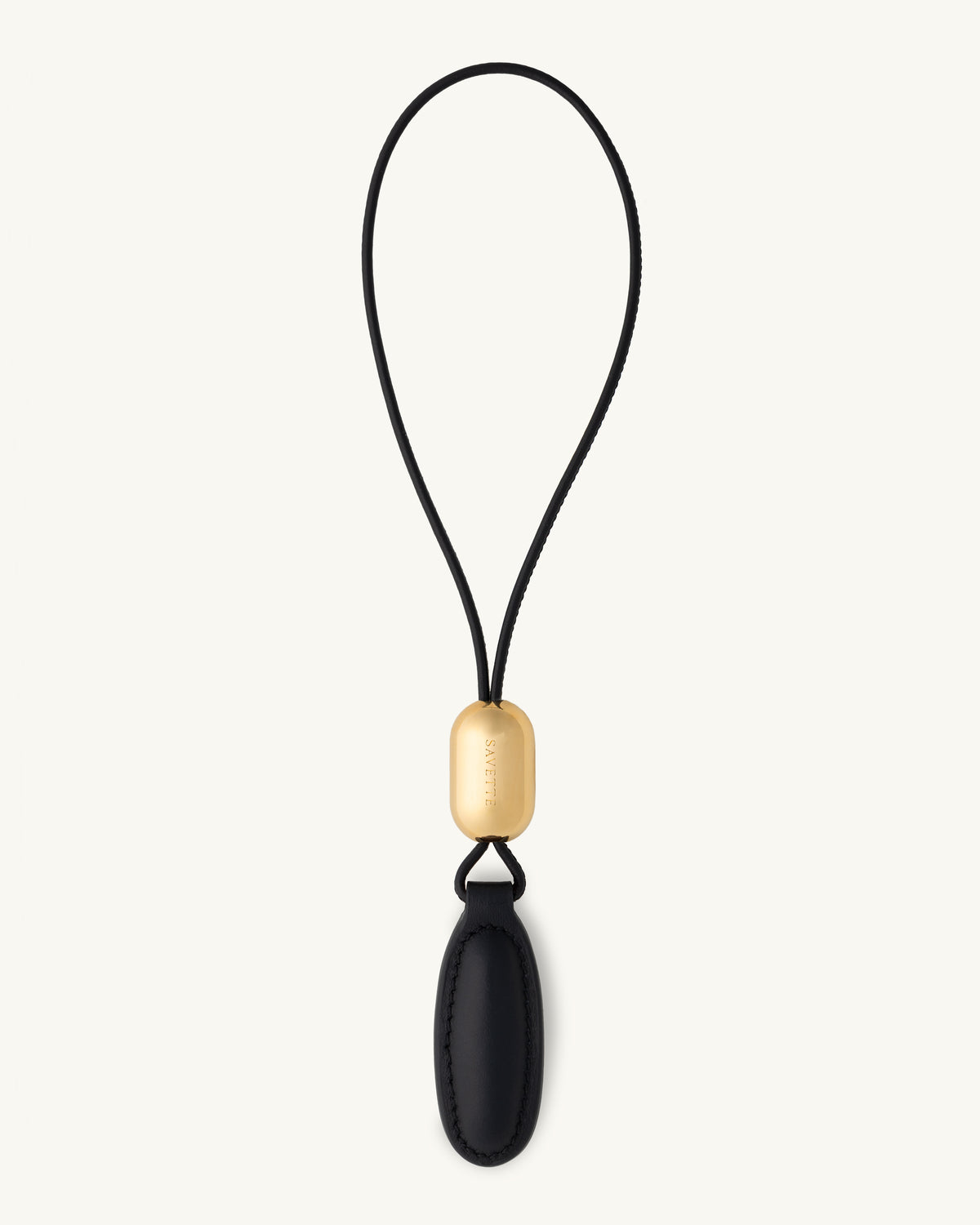 front view of a black leather charm on a white background